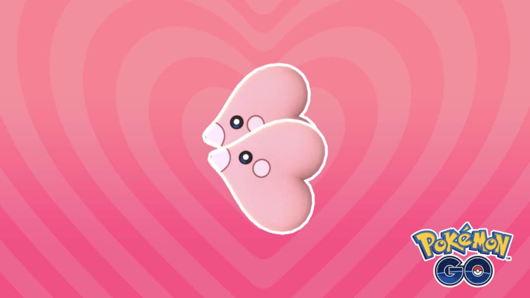 Two Luvdisc are next to each other as if they are about to kiss, with one positioned slightly behind the other. The background is a wave of pink hearts in darker and lighter shades. In the bottom right is the Pokémon GO logo