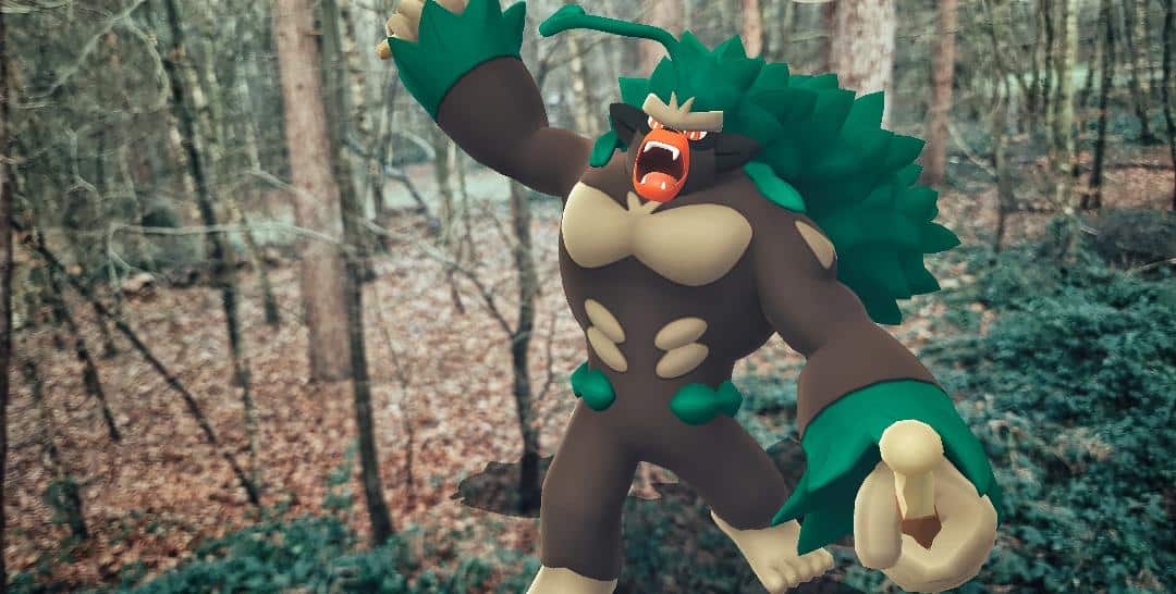 A huge Rillaboom looms towards the camera through an icy woodland. It has one fist raised in the air as if it is going to strike you with it, their mouth is open in a roar
