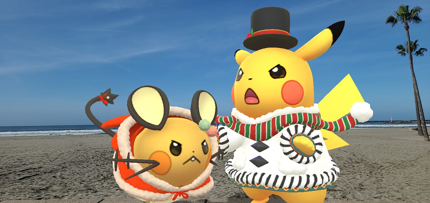 An angry costume Dedenne and winter jumper Pikachu are on a beach in the sunshine!