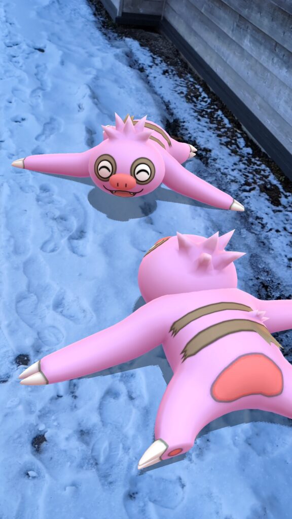 Two shiny Slakoth lay in the snow, looking at each other