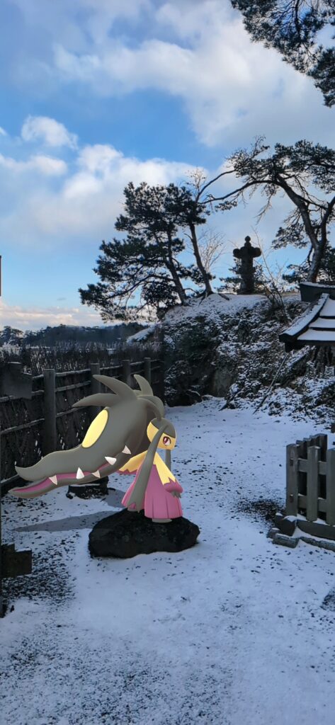 A Mega Mawile stands in the snow