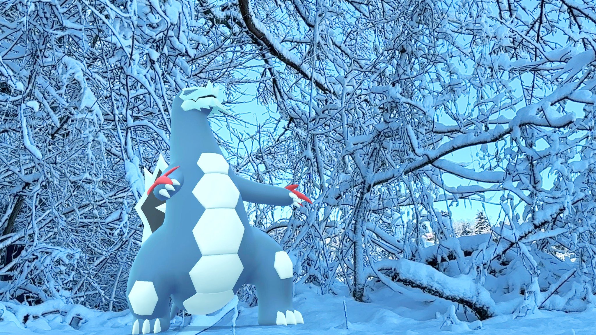 A Baxcalibur roars in the snow, with snow covered trees behind them