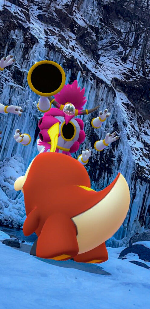 A Fuecoco looks up at an Unbound Hoopa in the snowy mountains