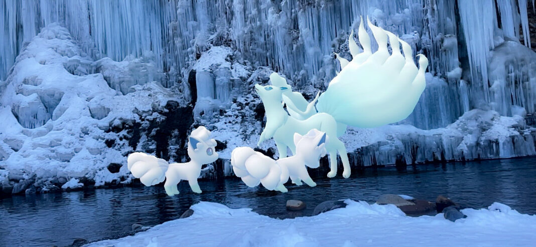 Two Alolan Vulpix look at an Alolan Ninetales in an incredible icy wonderland on a frozen lake