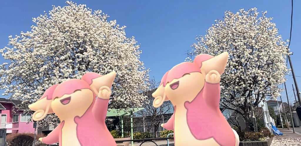 two audino dance surrounded by trees of white blossom