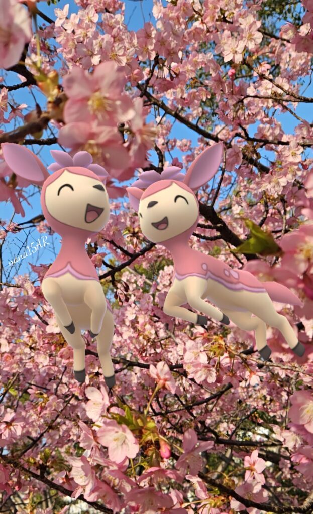 two shiny pink deerling jump in front of cherry blossom