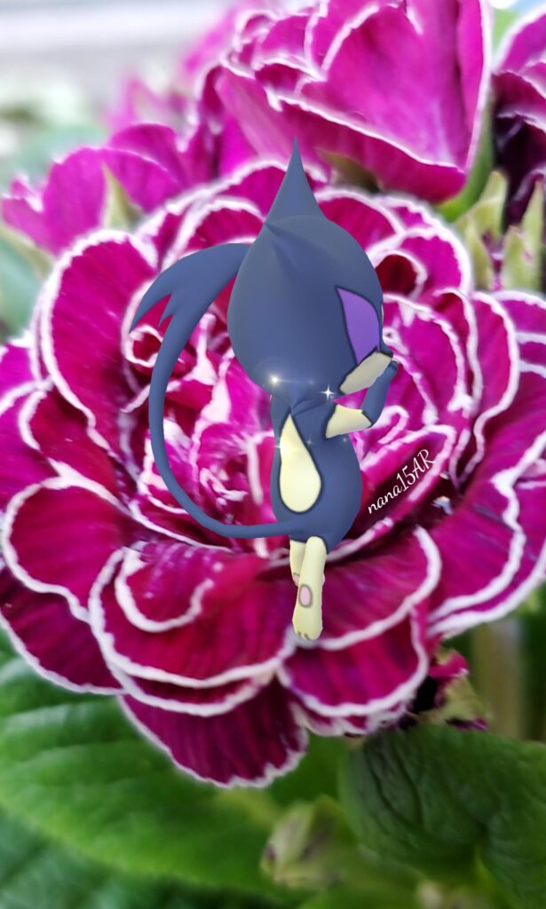 A shiny Purrloin on a purple flower