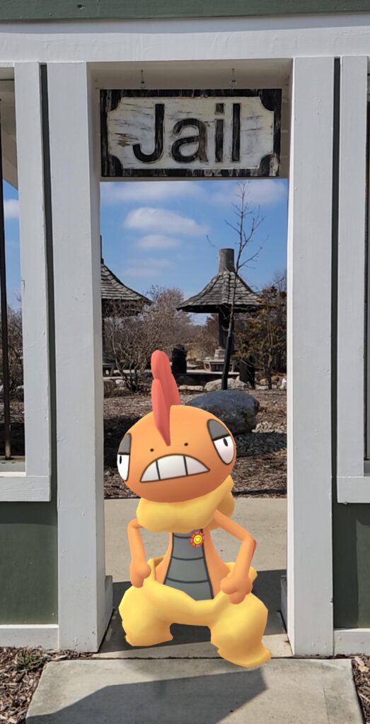 Scrafty in front of a jail sign