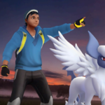 With a dark sky and a sunset in the background, a Pokémon trainer points to the right of the image, with a Mega Absol next to them. In the top left corner are the Pokémon GO, and Might and Mastery Season logos